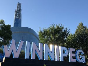 Winnipeg sign with Canadian Museum of Human Rights in the background